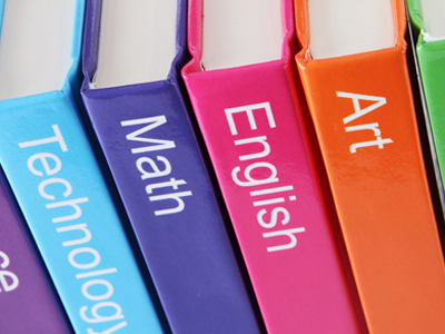 Row of textbooks for various school subjects