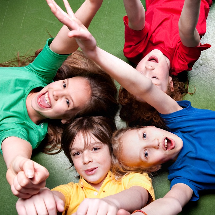 Happy Children Lying on the Ground