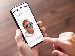A close-up of a smartphone showing an AI image generator app, displaying a man wearing large blue sunglasses, with a person’s hand holding and tapping the screen.