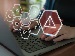 A person typing on a laptop with digital icons showing checkmarks and a warning triangle, representing success and error in AI or automated systems.