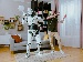 A humanoid robot and a man dancing together in a modern living room, with bookshelves, a sofa, and curtains in the background, illustrating fun AI integration in daily life.