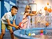 Two children playing with an interactive water exhibit at a science museum, experimenting with colourful balls and streams of water as part of a hands-on learning display.