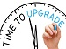A hand drawing the word “Upgrade” on a clock face with the phrase “Time to Upgrade” written across it, symbolising progress and improvement.