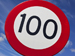 A 100 kilometres per hour signpost.