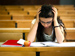 Unhappy girl sitting exam