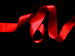 A red ribbon on a black background