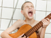 Child playing guitar and singing in shower