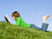 Child reading book outdoors