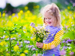 Child picking flowers in spring