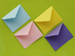 Four colorful envelopes on a green background