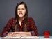 Woman looking thoughtful with dictionary and apple