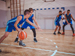 Basketball players playing on inside court