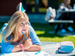 Girl writing in notebook sitting on grass