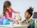 Two little girls having a tea party