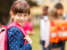 Schoolgirl with backpack looking at camera