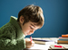 Boy at desk writing a story