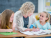 Teacher and schoolchildren writing in class