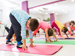 Kids exercising indoors on rubber mats