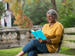 Woman on park bench reading a book