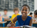 Grade 5 student writing at school desk