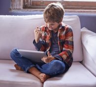 Boy who is happy with his computer calculations