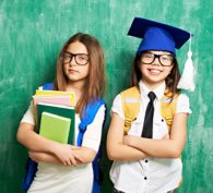 Two children looking pleased with their 11-Plus results