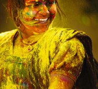 Happy girl covered in paint to illustrate diversity