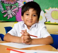 Young boy holding a pencil and about to write