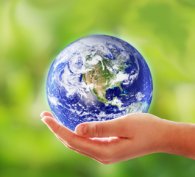 Hand holding a miniature globe of the world