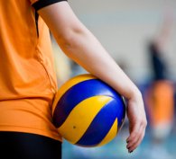 Boy standing patiently holding a ball